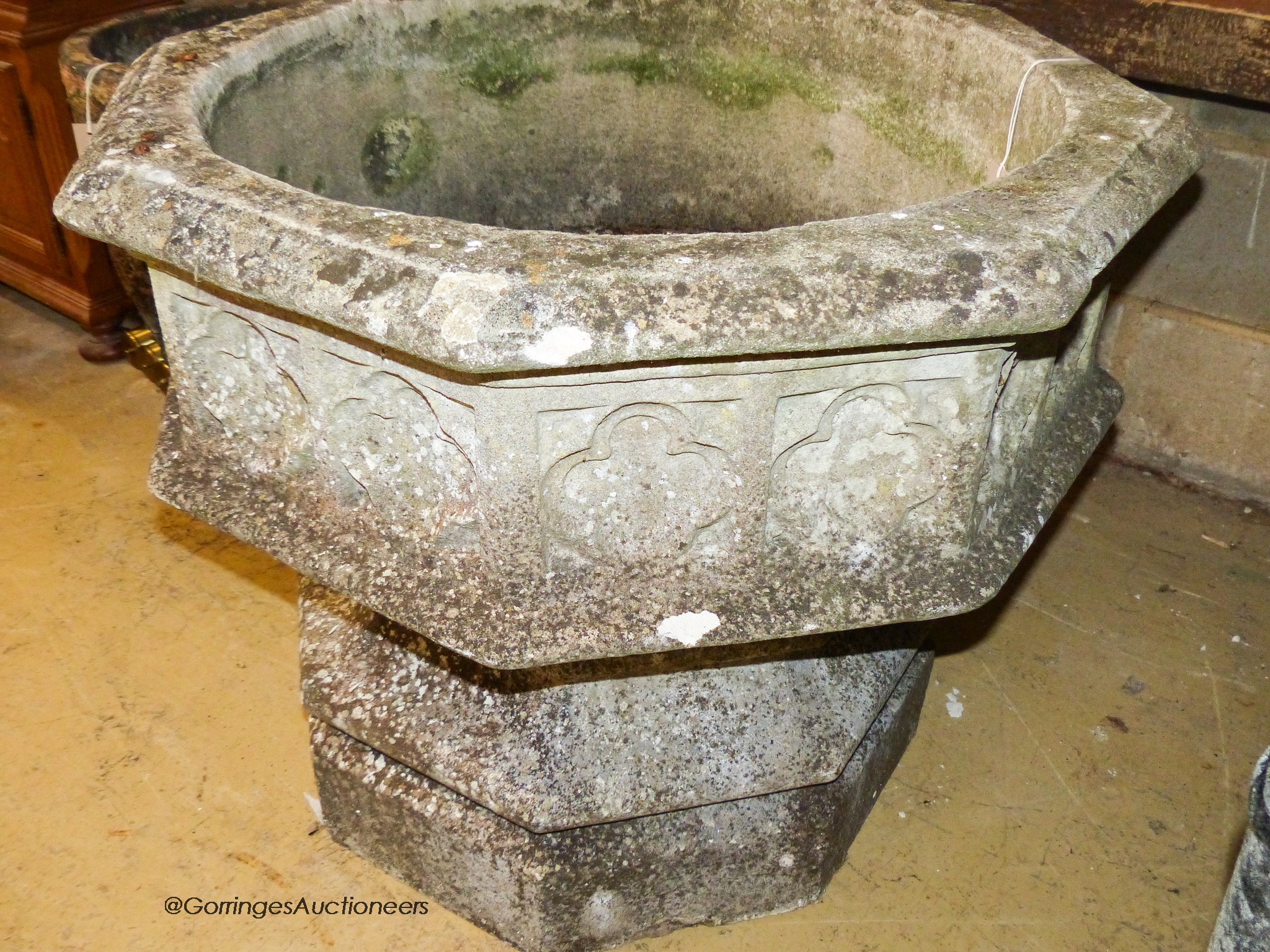 A large weathered Victorian octagonal carved stone font, width 80cm, height 67cm